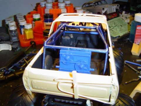 1979 Ford Bronco - Model truck with roll cage and large tires, showing 'FORD' script on the tailgate.