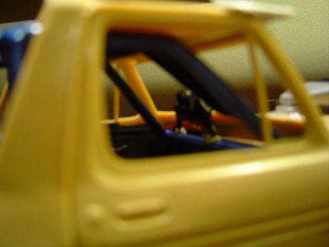 1979 Ford Bronco - Close-up of a model car's interior, showing a roll cage structure.