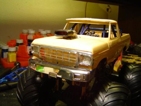 1979 Ford Bronco - A model truck with a prominent chrome grille and scoop is shown in a workshop setting.