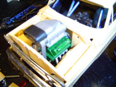 1979 Ford Bronco - Close-up view of a model car's engine bay, a green engine block and a prominent silver supercharger.