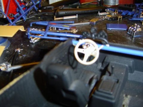 1979 Ford Bronco - Model car parts laid out on a workbench, ready for assembly.