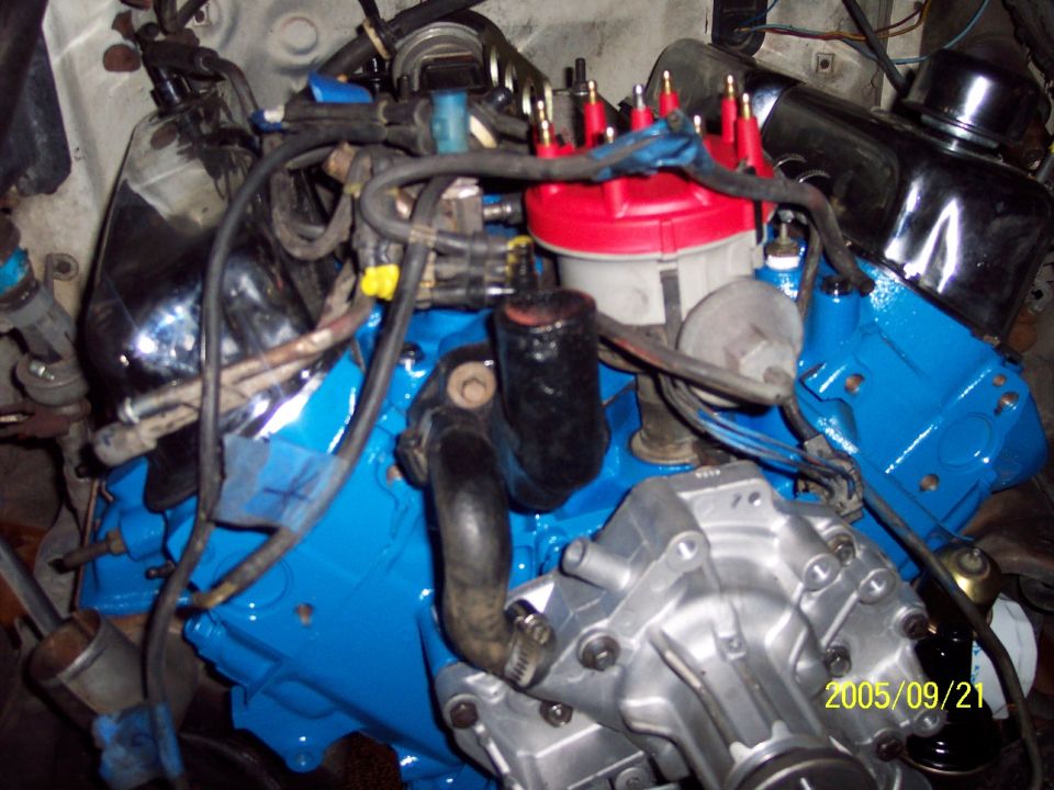Close-up of a blue engine block with red distributor cap and silver water pump. Date stamp reads 2005/09/21