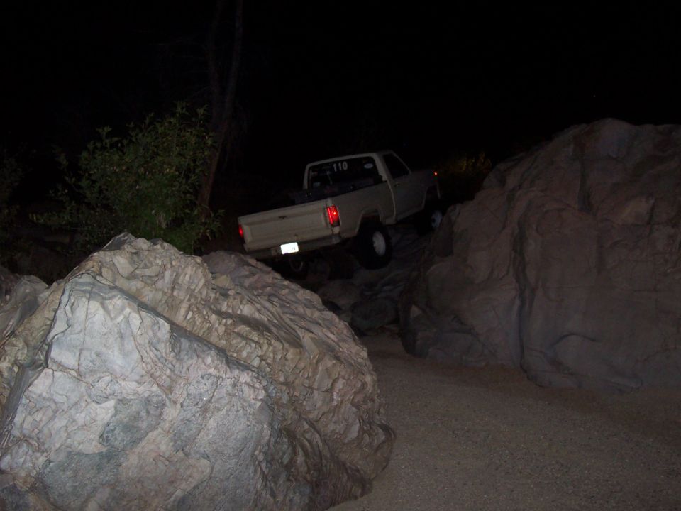 Through the squeeze, climbing out the rocks on the other side