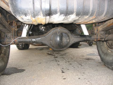 1985 Ford Bronco - Underside view shows the rear axle, fuel tank, and suspension components of a vehicle.