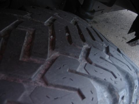 1985 Ford Bronco - A close-up view of a tire's tread pattern, showing the texture and depth of the grooves.