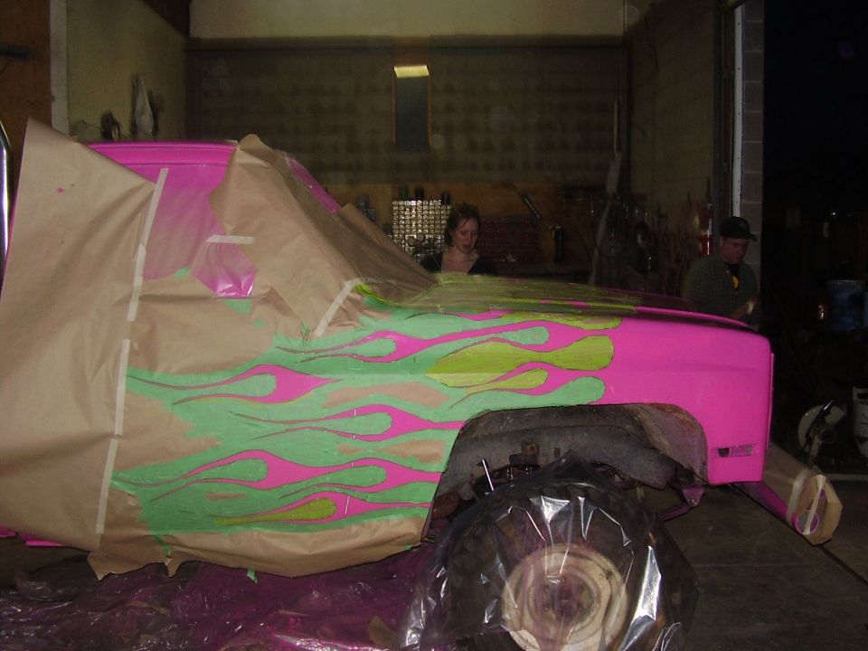 1981 Chevrolet C/K Pickup with pink and green flames being painted, covered in masking paper