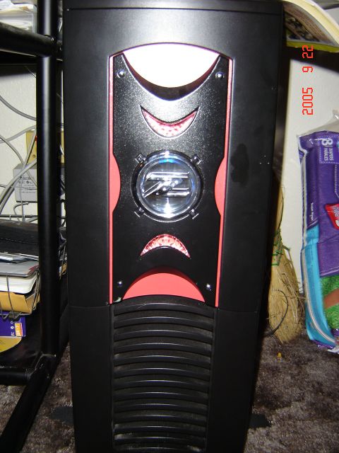 1993 Ford Bronco - A computer tower with a distinctive front panel design is shown in a cluttered environment.