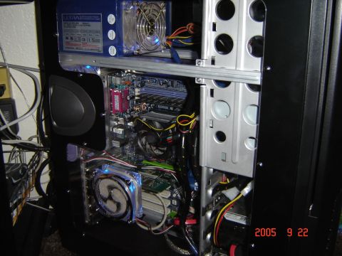 1993 Ford Bronco - Internal view of a computer case showing the motherboard, power supply unit, and cooling fans.