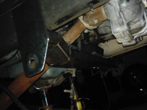 1978 Ford Bronco - The underside of a vehicle shows modifications and rust, with the drivetrain components visible.