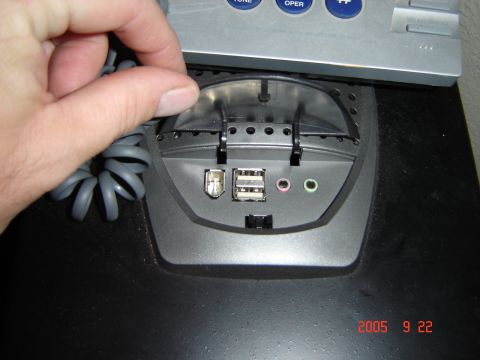 1993 Ford Bronco - A hand opens the cover of a computer peripheral, revealing USB and audio ports. The image includes a date stamp of 2005-09-22.