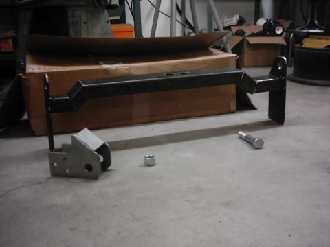 1978 Ford Bronco - A trailer hitch receiver and its associated hardware are laid out on a concrete surface.