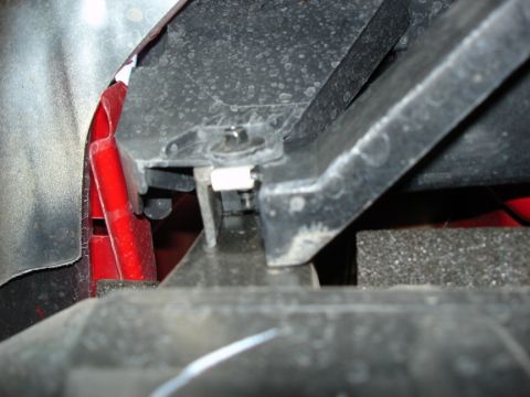 2005 Nissan Titan - Detail of a vehicle's bumper mounting bracket assembly, showing plastic and metal components.