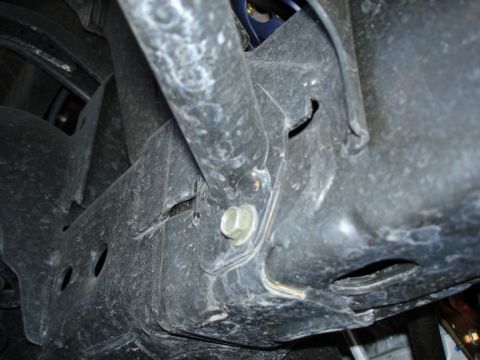 2005 Nissan Titan - Undercarriage view of a vehicle's frame and suspension system, with visible bolts and structural components.