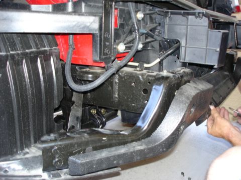 2005 Nissan Titan - Close-up view of the front bumper mounting structure and associated wiring harness components.