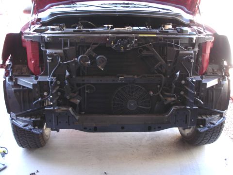 2005 Nissan Titan - Front view of a 2005 Nissan Titan with the bumper removed, revealing the radiator and fan assembly.