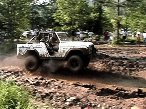 1969 Ford Bronco - A 1969 Ford Bronco navigates a challenging muddy course during an off-road event.