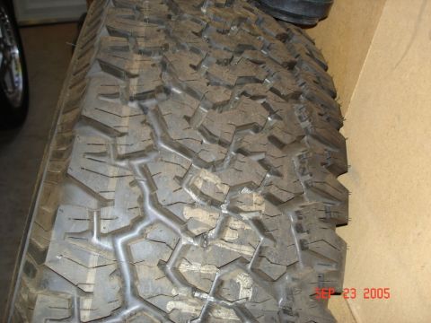 2005 Nissan Titan - A close-up view of a tire's tread pattern, with a visible date stamp.