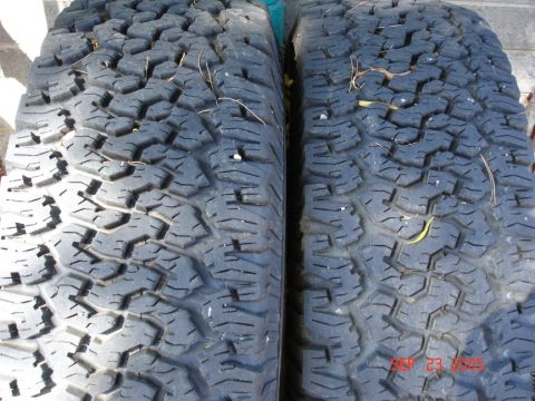 2005 Nissan Titan - Close-up view of two off-road tires, highlighting their tread design and condition.