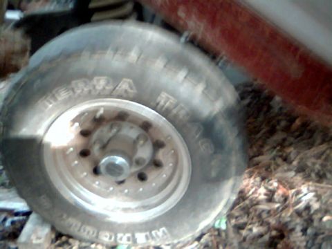 1992 Ford F-150 - A close-up view of a single truck tire and wheel, with some text visible on the tire's sidewall.