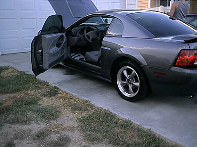 Dark gray 2004 Ford Mustang coupe, driver's door and hood open