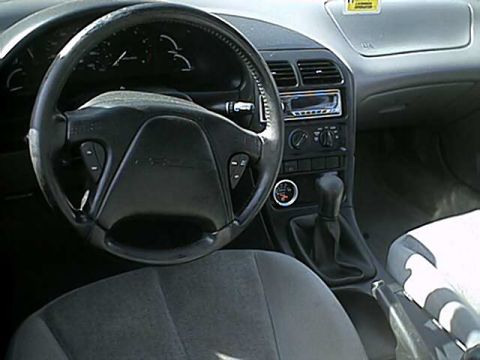 1996 Ford Probe - The interior of a 1996 Ford Probe shows the dashboard, steering wheel, and gear shifter.