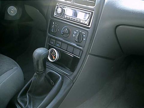 1996 Ford Probe - Interior shot showing the center console with an aftermarket gauge and gear shifter.
