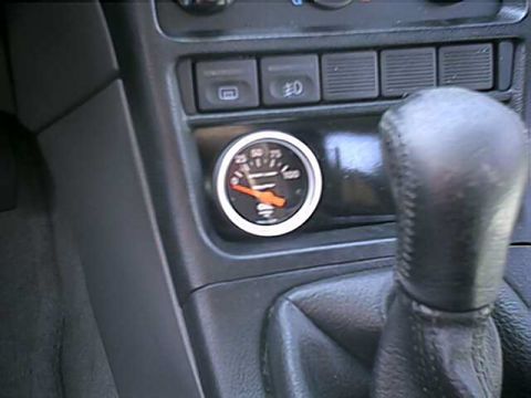1996 Ford Probe - A close-up shot of a car's interior, focusing on a gauge and the gear shifter.