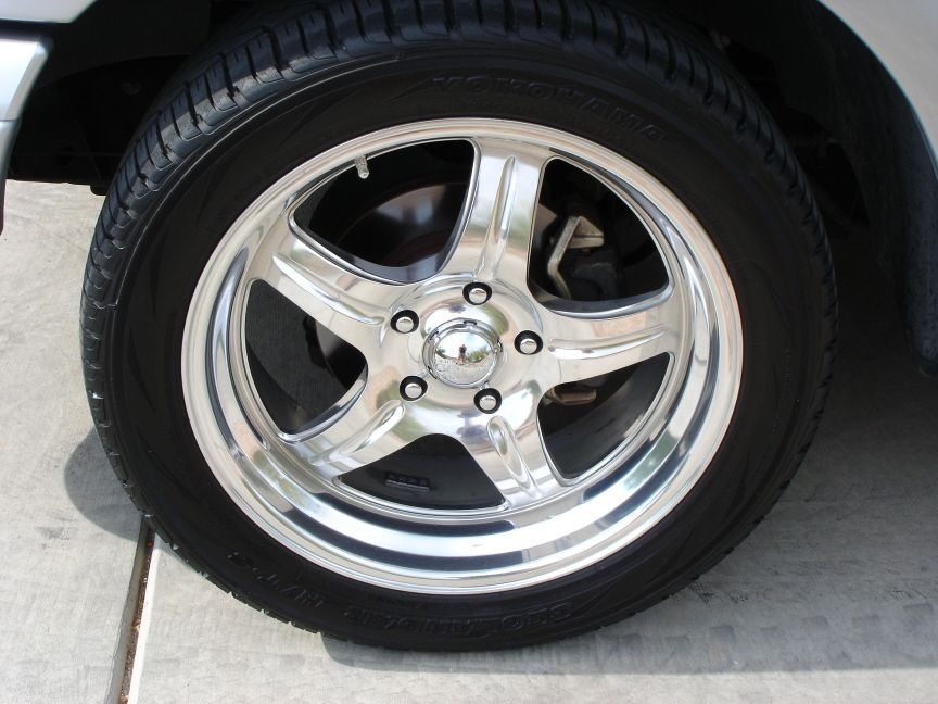 Polished 5-spoke alloy wheel with chrome center cap on Yokohama tire