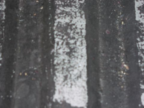 1979 Ford Bronco - A close-up view of a textured, dark surface with white paint marks and partially visible numbers.