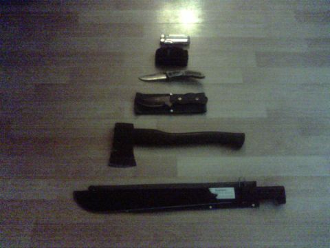 1990 Ford Ranger - Collection of outdoor tools including a multi-tool, knife, axe, and machete.