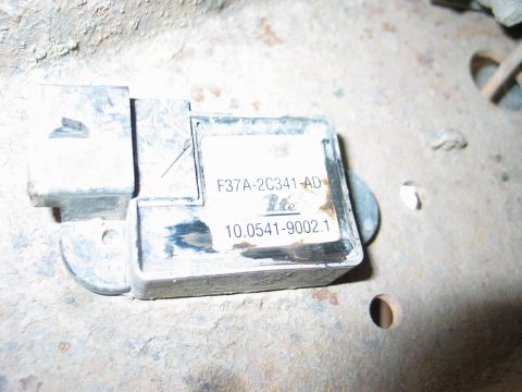 1995 Ford Bronco - A close-up view of a vehicle's electronic sensor module, showing its part number and manufacturer details.