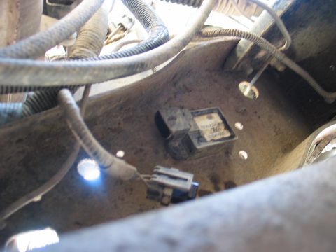 1995 Ford Bronco - Close-up view of a transmission sensor and its wiring harness, with some text visible on the sensor's label.
