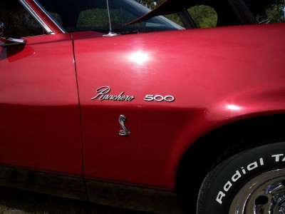 1972 Ford Ranchero - The side fender of a red 1972 Ford Ranchero 500 shows its model designation and a Cobra emblem.