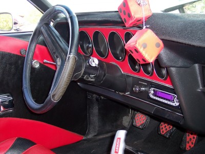 1972 Ford Ranchero - Interior view of a 1972 Ford Ranchero, a red dashboard and custom steering wheel cover.