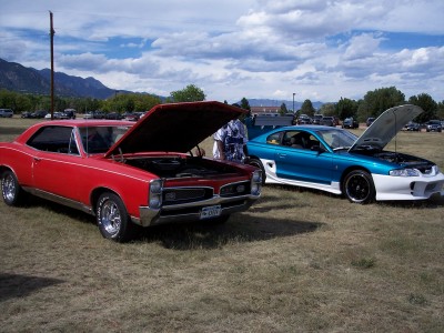 1972 Ford Ranchero - Two cars, a red 1967 Pontiac GTO and a blue modified vehicle, are parked with their hoods up.