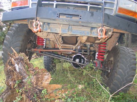 1995 Ford Bronco - Undercarriage view of a modified 1992 Ford Bronco, showing its heavy-duty suspension and off-road tires.