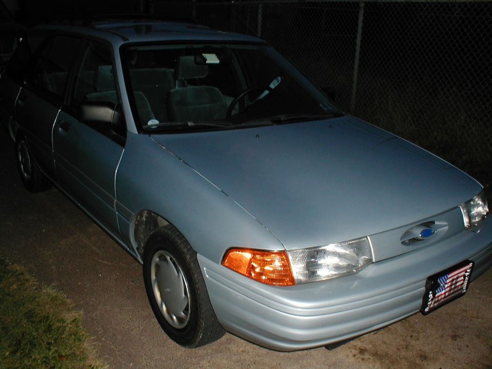 Light blue station wagon with a blue Ford emblem on the grille. License plate is visible