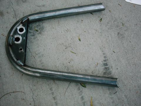 1978 Ford Bronco - A custom fabricated metal hoop with mounting points sits on a concrete surface.