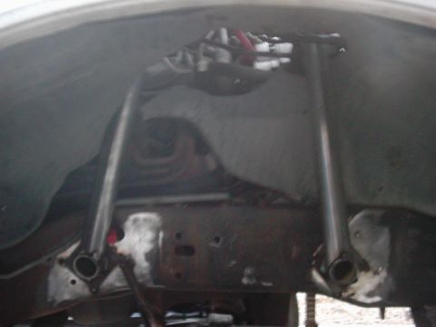 1978 Ford Bronco - Close-up of the undercarriage reveals the frame and suspension system of a vehicle.