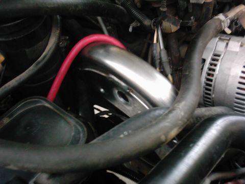 1978 Ford Bronco - Engine bay components including alternator, exhaust pipe, and various hoses are visible.