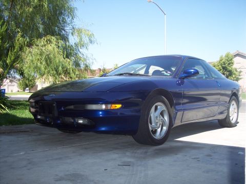 1995 Ford Probe - A blue 1995 Ford Probe is parked in a driveway on a sunny day.