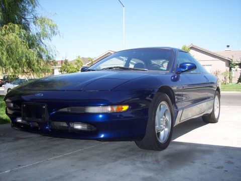 1995 Ford Probe - Front view of a blue 1995 Ford Probe parked on a concrete driveway.