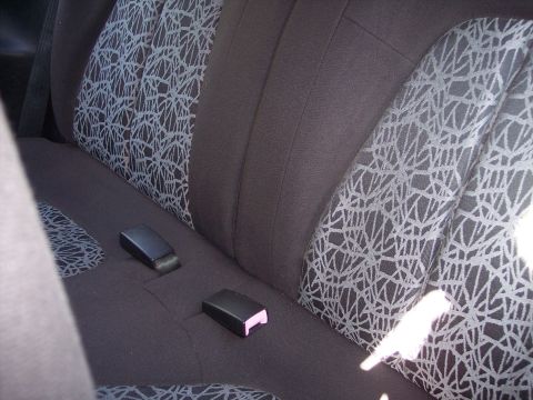 1995 Ford Probe - The interior of a car shows the rear seats with dark upholstery and a distinctive pattern on the seat cushions.