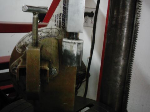 1978 Ford Bronco - Close-up of an alignment machine part, showing a degree gauge and mechanical components.