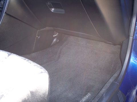 1995 Ford Probe - The interior floor and lower dashboard area of a blue vehicle are visible, with a watermark for Supermotors.net.