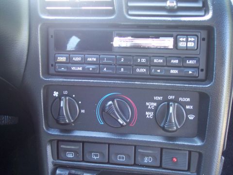 1995 Ford Probe - Close-up of a car's interior dashboard, showing the radio and climate control system.