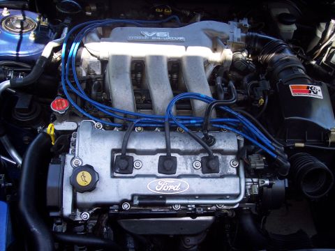 1995 Ford Probe - Close-up of a V6 engine bay, a Ford intake manifold and blue spark plug wires.