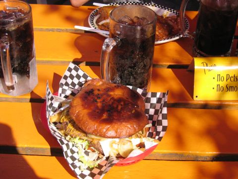 1999 Ford Crown Victoria - A meal is served outdoors with drinks and a burger on a checkered paper liner.