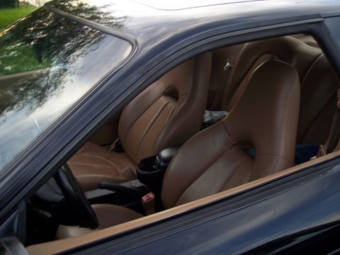 1995 Ford Probe - Interior view of a car with brown leather seats and a center console.