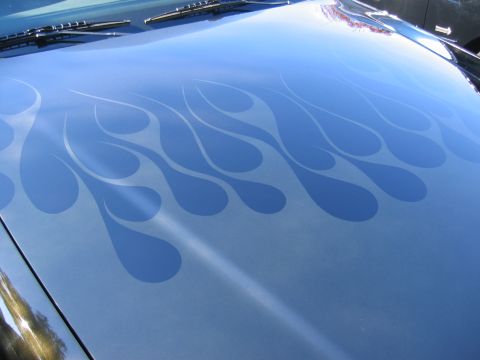 1999 Ford Crown Victoria - Car hood with custom flame graphics. The Supermotors.net logo is visible in the lower right corner.